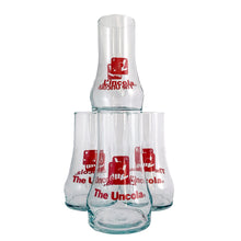 Load image into Gallery viewer, Vintage set of four, 7Up bilingual upside down drinking glasses with the 7Up logo in red along with their classic tagline, &quot;The Uncola&quot; in English and &quot;L&#39;encola&quot; in French. The glass come in the original cardboard tube with 7Up logo and red plastic end caps. Crafted by Libbey Glass, Canada, circa 1970s. A great addition to promotional advertising and glassware collections!  Glasses are in excellent condition, never used, no chips/wear. The tube has water damage, but still sturdy. Each glass is marked with t
