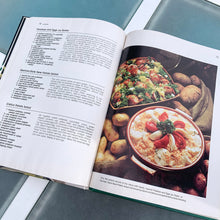 Load image into Gallery viewer, Better Homes and Gardens is known for its fabulous cookbooks. This hardcover cookbook focuses on their all-time favourite vegetable inspired recipes. Its 96 pages are filled with amazing  recipes along with many colour photographs. Originally published by Meredith Corporation, USA, 1977. This is the second printing, 1983.   In great vintage condition with normal age-related yellowing.   
