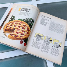 Load image into Gallery viewer, Better Homes and Gardens is known for its fabulous cookbooks. This hardcover cookbook focuses on its Pies and Cakes recipes. Its 90 pages are filled with amazing  recipes along with many colour photographs. Originally published by Meredith Corporation, USA, 1966. This is the fifth printing, 1968.   In great vintage condition with normal age-related yellowing.
