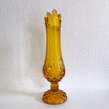 Load image into Gallery viewer, Glow in the dark elegance! Show off your daring style with this vintage mid-century &quot;Moon and Stars&quot; art glass swung vase that glows under black light. Crafted from amber glass with a striking moon and stars design, this American-made Kanawha Glass vase would be an unforgettable addition to any decor!  In excellent condition, free from chips/cracks.  Measures 3 1/2 x 12 1/8 inches
