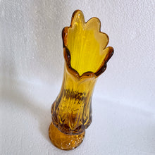 Load image into Gallery viewer, Glow in the dark elegance! Show off your daring style with this vintage mid-century &quot;Moon and Stars&quot; art glass swung vase that glows under black light. Crafted from amber glass with a striking moon and stars design, this American-made Kanawha Glass vase would be an unforgettable addition to any decor!  In excellent condition, free from chips/cracks.  Measures 3 1/2 x 12 1/8 inches
