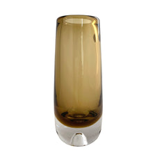 Load image into Gallery viewer, Vintage modernist amber glass vase featuring a clear base with bubble. Crafted by Magnor Glassverk, Norway, 1960s. A stunning piece of art glass to elevate your home's decor.

In excellent condition, no chips. Original tag.

Measures 2 3/4 x 7 1/8 inches
