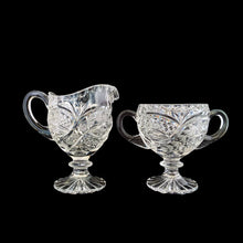 Load image into Gallery viewer, Elegant vintage American Brilliant Cut Glass Eleanor creamer and double handled open sugar. Crafted in the USA, early 20th century. These beauties are cut with an infinity pattern of diamond and cut leaves, crimped rims and sawtooth cut bottoms. Adds a touch of old world elegance to any tablescape.

In excellent condition, no chips.

Creamer measures 3 x 4 1/2 x 5 inches

Sugar measures 5 1/2 x 3 1/2 x 4 inches
