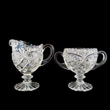 Load image into Gallery viewer, Elegant vintage American Brilliant Cut Glass Eleanor creamer and double handled open sugar. Crafted in the USA, early 20th century. These beauties are cut with an infinity pattern of diamond and cut leaves, crimped rims and sawtooth cut bottoms. Adds a touch of old world elegance to any tablescape.

In excellent condition, no chips.

Creamer measures 3 x 4 1/2 x 5 inches

Sugar measures 5 1/2 x 3 1/2 x 4 inches

