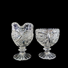 Load image into Gallery viewer, Elegant vintage American Brilliant Cut Glass Eleanor creamer and double handled open sugar. Crafted in the USA, early 20th century. These beauties are cut with an infinity pattern of diamond and cut leaves, crimped rims and sawtooth cut bottoms. Adds a touch of old world elegance to any tablescape.

In excellent condition, no chips.

Creamer measures 3 x 4 1/2 x 5 inches

Sugar measures 5 1/2 x 3 1/2 x 4 inches
