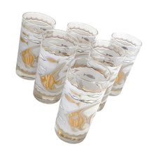 Load image into Gallery viewer, This stunning set of six mid-century era vintage highball glass tumblers are decorated with 22 karat gold angelfish and white seahorses, swimming in a frosted sea of waves with small stylized fish in gold and white in between scalloped gold borders. Crafted by Libbey Glass, USA, 1950s. These beauties will add an exquisite touch of Hollywood Regency style to any occasion - indulge your guests with these truly spectacular cocktail glasses while amping up the glam factor of your bar cart!
