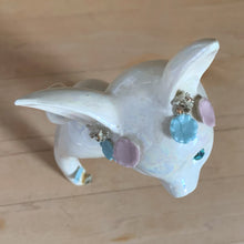 Load image into Gallery viewer, Adorable vintage mid-century era anthropomorphic deer ceramic figurine, glazed in iridescent white with blue rhinestone eyes, pink and blue flowers and gold gilt spaghetti details. Crafted by&nbsp;Lefton, Japan, circa 1950s. This sweet-faced deer is sure to delight everyone and it will make a wonderful addition to your Christmas holiday decor!

In good vintage condition. There is a chip to one blue flower, but otherwise excellent. Marked Japan and number 5845.

Measures 3 1/2 x 2 1/2 x 7 inches
