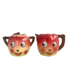 Load image into Gallery viewer, Adorable hand painted anthropomorphic apple face creamer and covered sugar. Crafted by PY, Japan, 1950s. A sweet mid-century kitschy set makes a great addition to your ceramics collection and kitchen decor!

In excellent vintage condition, no chips/cracks, normal crazing present.

Creamer measures 3 3/4 x 3 1/4 inches

Sugar measures 3 1/4 x 3 3/8 inches
