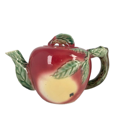 Rare Find! Sweet vintage mid-century era majolica style figural apple shaped ceramics, including a teapot, creamer and covered sugar featuring brown branch handles and green leaves. Crafted by Metroware, Japan, circa 1940s. Perfect to add kitsch style to your kitchen decor. In excellent used vintage condition, free from chips, with interior staining and crazing. Measures 8 1/2 x 4 3/4 x 5 3/4 inches