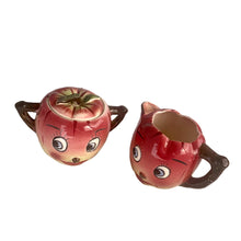 Load image into Gallery viewer, Adorable hand painted anthropomorphic apple face creamer and covered sugar. Crafted by PY, Japan, 1950s. A sweet mid-century kitschy set makes a great addition to your ceramics collection and kitchen decor!

In excellent vintage condition, no chips/cracks, normal crazing present.

Creamer measures 3 3/4 x 3 1/4 inches

Sugar measures 3 1/4 x 3 3/8 inches
