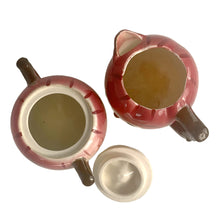 Load image into Gallery viewer, Adorable hand painted anthropomorphic apple face creamer and covered sugar. Crafted by PY, Japan, 1950s. A sweet mid-century kitschy set makes a great addition to your ceramics collection and kitchen decor!

In excellent vintage condition, no chips/cracks, normal crazing present.

Creamer measures 3 3/4 x 3 1/4 inches

Sugar measures 3 1/4 x 3 3/8 inches
