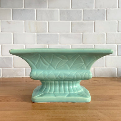 Vintage glossy aqua glaze rectangular ceramic stoneware pedestal planter featuring an impressed pattern. Crafted by Robinson Ransbottom Pottery Co., USA, 1950s. A beautiful piece to add to your art pottery collection and plant up your favourite succulents or houseplant!

In excellent condition, cracks/repairs. There is minor chipping at the corner of the base which appears to have happened during the manufacturing process. Maker's marks.

Measures 8 5/8 x 5 x 4 3/4 inches