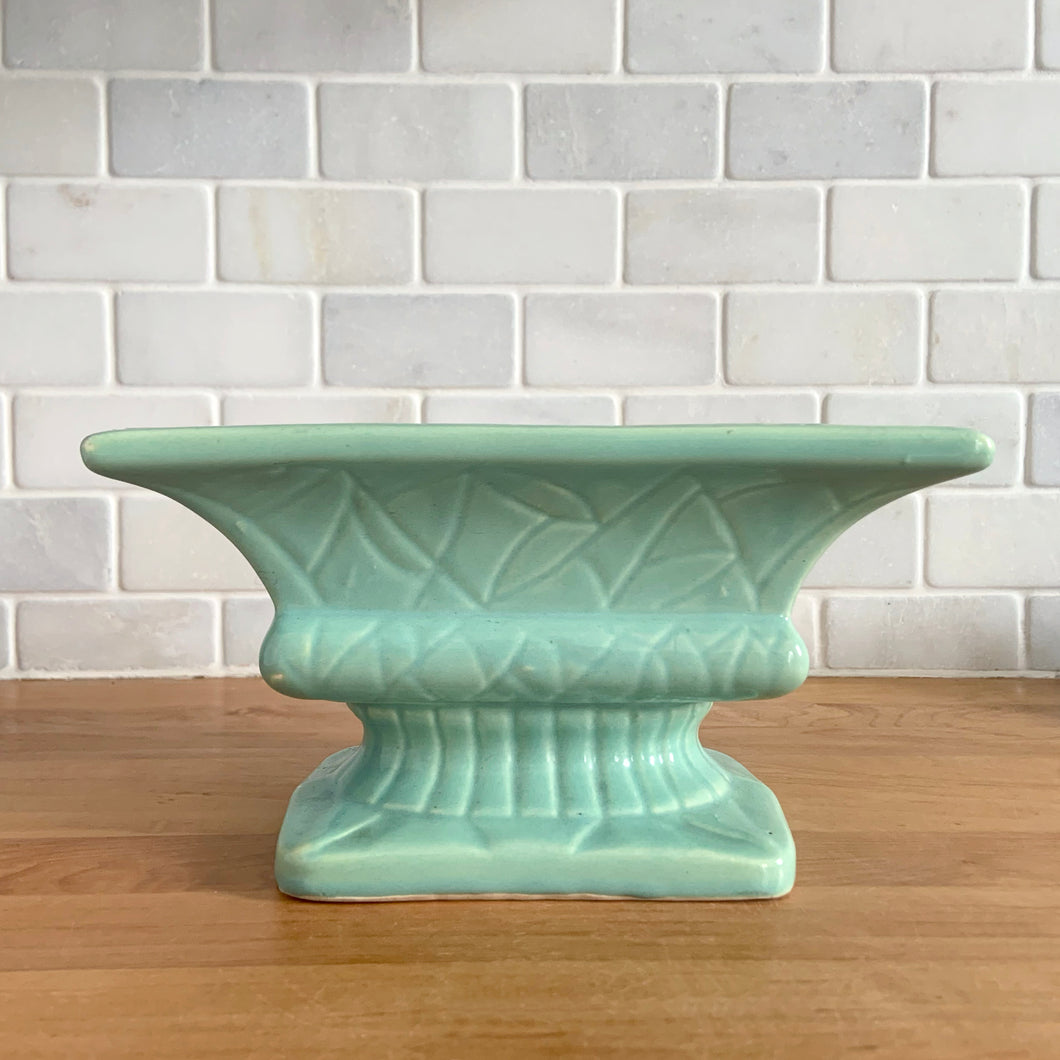 Vintage glossy aqua glaze rectangular ceramic stoneware pedestal planter featuring an impressed pattern. Crafted by Robinson Ransbottom Pottery Co., USA, 1950s. A beautiful piece to add to your art pottery collection and plant up your favourite succulents or houseplant!

In excellent condition, cracks/repairs. There is minor chipping at the corner of the base which appears to have happened during the manufacturing process. Maker's marks.

Measures 8 5/8 x 5 x 4 3/4 inches