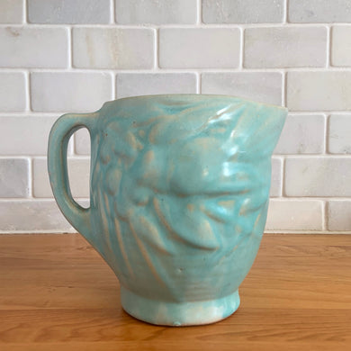 Vintage matte aqua glazed Bird in Berries pitcher. Crafted by McCoy Pottery, USA, 1935. This rare and highly collectible pitcher is the perfect for flowers or decorative display and makes a lovely gift for an art pottery collector.

In excellent vintage condition, no chips,cracks or repairs, manufacturer's glaze pops. Unmarked.

Measures 4 x 5 3/4 x 4 7/8 inches (incl. handle/spout)