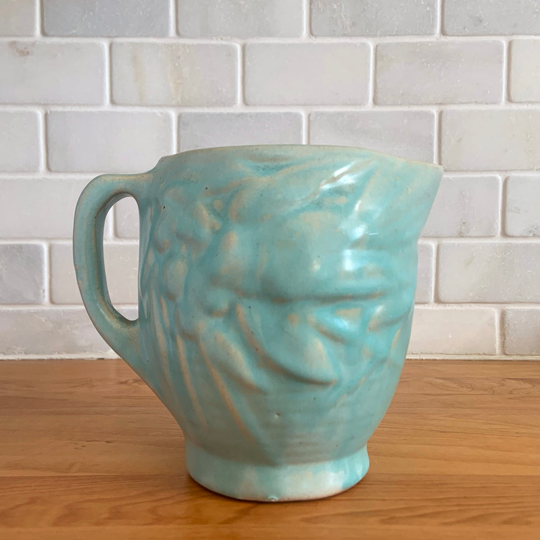 Vintage matte aqua glazed Bird in Berries pitcher. Crafted by McCoy Pottery, USA, 1935. This rare and highly collectible pitcher is the perfect for flowers or decorative display and makes a lovely gift for an art pottery collector.

In excellent vintage condition, no chips,cracks or repairs, manufacturer's glaze pops. Unmarked.

Measures 4 x 5 3/4 x 4 7/8 inches (incl. handle/spout)