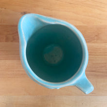 Load image into Gallery viewer, Vintage matte aqua glazed Bird in Berries pitcher. Crafted by McCoy Pottery, USA, 1935. This rare and highly collectible pitcher is the perfect for flowers or decorative display and makes a lovely gift for an art pottery collector.

In excellent vintage condition, no chips,cracks or repairs, manufacturer&#39;s glaze pops. Unmarked.

Measures 4 x 5 3/4 x 4 7/8 inches (incl. handle/spout)
