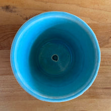 Load image into Gallery viewer, Vintage Art Deco aqua blue Tierra Cushion planter with attached underplate. Crafted by McCoy Pottery, 1950. This rare piece is must for any art pottery collector! A lovely way to enhance your home's decor or give as a gift!

In excellent vintage condition, no chips/cracks/repairs. Typical age-related crazing, manufacturer's glaze pops. Maker's marks.

Measures 4 x 3 3/8 inches
