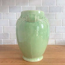 Load image into Gallery viewer, Vintage mid-century gloss aqua handled vase with embossed leaves. Crafted by McCoy Pottery, 1948. This lovely vase is must for any art pottery collector!

In excellent condition, no chips/cracks/repairs, crazing commensurate with age and manufacturing glaze pops. Maker&#39;s mark on the bottom.

Measures 5 1/2 x 8 inches
