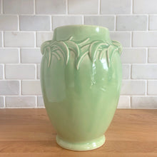 Load image into Gallery viewer, Vintage mid-century gloss aqua handled vase with embossed leaves. Crafted by McCoy Pottery, 1948. This lovely vase is must for any art pottery collector!

In excellent condition, no chips/cracks/repairs, crazing commensurate with age and manufacturing glaze pops. Maker&#39;s mark on the bottom.

Measures 5 1/2 x 8 inches
