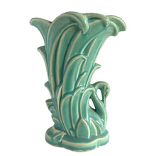 Load image into Gallery viewer, Beautiful vintage Swan vase glazed in gloss aqua, features a swan swimming in the reeds. Crafted by McCoy Pottery, 1948. This vase is must for any art pottery collector!

In excellent vintage condition, no chips, no cracks, no repairs. Minor manufacturer's defects, see photos. Maker's mark on the bottom.

Measures 6 7/8 x 4 1/8 x 9 1/4 inches

