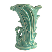 Load image into Gallery viewer, Beautiful vintage Swan vase glazed in gloss aqua, features a swan swimming in the reeds. Crafted by McCoy Pottery, 1948. This vase is must for any art pottery collector!

In excellent vintage condition, no chips, no cracks, no repairs. Minor manufacturer's defects, see photos. Maker's mark on the bottom.

Measures 6 7/8 x 4 1/8 x 9 1/4 inches
