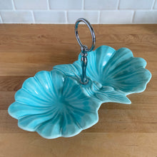 Load image into Gallery viewer, Vintage mid-century era aqua lotus leaf 2-part divided candy dish with silver-toned ring handle. Crafted by California Pottery, USA, 1950s. A lovely serving piece for nuts, candies....whatever you fancy!

In excellent condition, no chips/cracks/repairs. Reinforced handle with new rubber washer.

Measures 10 3/4 x 6 x 1 3/4 inches (6 1/4 inches with handle)
