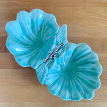 Load image into Gallery viewer, Vintage mid-century era aqua lotus leaf 2-part divided candy dish with silver-toned ring handle. Crafted by California Pottery, USA, 1950s. A lovely serving piece for nuts, candies....whatever you fancy!

In excellent condition, no chips/cracks/repairs. Reinforced handle with new rubber washer.

Measures 10 3/4 x 6 x 1 3/4 inches (6 1/4 inches with handle)
