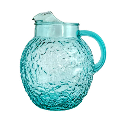 Vintage aqua Miliano ice lip glass pitcher features a textured surface and ribbed handle. Crafted by Anchor Hocking, between 1960-1969. A highly sought after colour and a fab centrepiece for your drink service and barware!!!

In excellent condition, no chips.

Measures 7 x 9 inches

Capacity 96 ounces