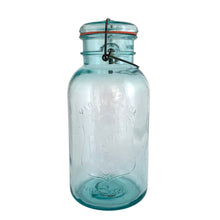 Load image into Gallery viewer, Vintage Perfect Seal aqua glass mason jar,featuring glass lid and wire bail closure. Produced by the Hamilton Glass Works in the early 20th century. These jars are fabulous for storing dry goods or may be repurposed as a vase. Perfect for farmhouse and cottage core decor.  In as found condition.  Measures 4 1/2 x 9 1/2 inches  Capacity 2 quarts (1/2 gallon)
