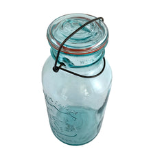 Load image into Gallery viewer, Vintage Perfect Seal aqua glass mason jar,featuring glass lid and wire bail closure. Produced by the Hamilton Glass Works in the early 20th century. These jars are fabulous for storing dry goods or may be repurposed as a vase. Perfect for farmhouse and cottage core decor.  In as found condition.  Measures 4 1/2 x 9 1/2 inches  Capacity 2 quarts (1/2 gallon)
