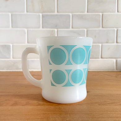 Highly collectible vintage Fire-King Ware milk glass mug with two rows of turquoise rings, D-handle. Crafted by Anchor Hocking, USA, 1960s. A must-have for any Fire-King collector!

In excellent condition, no chips, cracks or repairs. Paint is vibrant and shiny.

Measures 3 1/4 x 3 3/8 inches