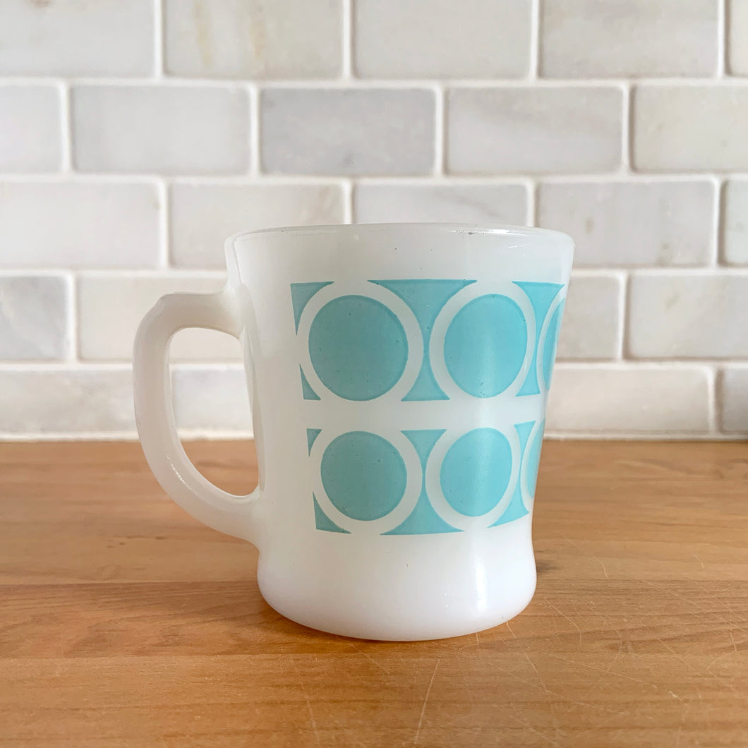 Highly collectible vintage Fire-King Ware milk glass mug with two rows of turquoise rings, D-handle. Crafted by Anchor Hocking, USA, 1960s. A must-have for any Fire-King collector!

In excellent condition, no chips, cracks or repairs. Paint is vibrant and shiny.

Measures 3 1/4 x 3 3/8 inches
