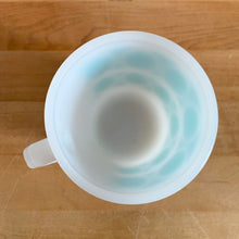 Load image into Gallery viewer, Highly collectible vintage Fire-King Ware milk glass mug with two rows of turquoise rings, D-handle. Crafted by Anchor Hocking, USA, 1960s. A must-have for any Fire-King collector!

In excellent condition, no chips, cracks or repairs. Paint is vibrant and shiny.

Measures 3 1/4 x 3 3/8 inches
