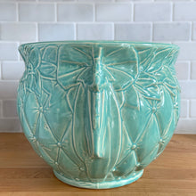 Load image into Gallery viewer, Large vintage aqua gloss glazed Tierra Cushion jardiniere planter pot, features an overlapping floral leaf rim and diamond quilted body with ribbon handles. Crafted by McCoy Pottery, USA, 1950s. A must-have for any McCoy collector or container gardener!

In excellent condition, no chips/cracks/repairs, manufacturer&#39;s glaze pops. Maker&#39;s mark.

Measures 10 3/8 x 8 1/2 inches
