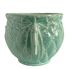 Load image into Gallery viewer, Large vintage TIerra Cushion jardiniere planter pot, aqua gloss glaze, features an overlapping floral leaf pattern around the top rim, a diamond quilted body and ribbon handles. Crafted by McCoy Pottery, USA, 1950s. A must-have for any McCoy collector or gardener!

In excellent condition, free from chips, cracks or repairs, with a manufacturer's defect at the rim, see photo. Maker's mark is on the bottom.

Measures 8 3/4 x 7 1/2 inches
