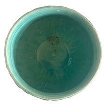 Load image into Gallery viewer, Large vintage TIerra Cushion jardiniere planter pot, aqua gloss glaze, features an overlapping floral leaf pattern around the top rim, a diamond quilted body and ribbon handles. Crafted by McCoy Pottery, USA, 1950s. A must-have for any McCoy collector or gardener!

In excellent condition, free from chips, cracks or repairs, with a manufacturer's defect at the rim, see photo. Maker's mark is on the bottom.

Measures 8 3/4 x 7 1/2 inches
