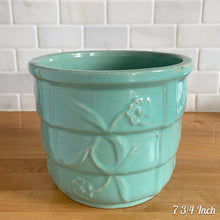 Load image into Gallery viewer, Vintage aqua blue glaze ceramic jardiniere planter featuring stacked body with embossed flowers, 1631. Crafted by Robinson Ransbottom Pottery Co., USA, 1940s. A beautiful piece to add to your art pottery collection!

In excellent condition, no chips/cracks/repairs. Typical manufacturers glaze pops. Maker&#39;s marks.

7 3/4 Inch: measures 7 3/4 x 6 1/2 inches
