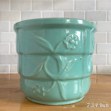 Load image into Gallery viewer, Vintage aqua blue glaze ceramic jardiniere planter featuring stacked body with embossed flowers, 1631. Crafted by Robinson Ransbottom Pottery Co., USA, 1940s. A beautiful piece to add to your art pottery collection!

In excellent condition, no chips/cracks/repairs. Typical manufacturers glaze pops. Maker&#39;s marks.

7 3/4 Inch: measures 7 3/4 x 6 1/2 inches
