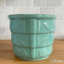 Load image into Gallery viewer, Vintage aqua blue glaze ceramic jardiniere planter featuring stacked body with embossed flowers, 1631. Crafted by Robinson Ransbottom Pottery Co., USA, 1940s. A beautiful piece to add to your art pottery collection!

In excellent condition, no chips/cracks/repairs. Typical manufacturers glaze pops. Maker&#39;s marks.

7 3/4 Inch: measures 7 3/4 x 6 1/2 inches
