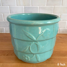 Load image into Gallery viewer, Vintage aqua blue glaze ceramic jardiniere planter featuring stacked body with embossed flowers, 1631. Crafted by Robinson Ransbottom Pottery Co., USA, 1940s. A beautiful piece to add to your art pottery collection!

In excellent condition, no chips/cracks/repairs. Typical manufacturers glaze pops. Maker&#39;s marks.

8 Inch: measures 8 x 6 1/2 inches
