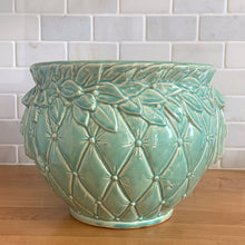 Load image into Gallery viewer, Large vintage Tierra Cushion jardiniere planter pot, aqua gloss glaze, features an overlapping floral leaf pattern around the top rim, a diamond quilted body and ribbon handles. Crafted by McCoy Pottery, USA, 1950s. A must-have for any McCoy collector or gardener!

In excellent condition, free from chips, cracks or repairs, with a manufacturer's glaze pops and like defects, see photo. Maker's mark.

Measures 9 x 7 1/4 inches
