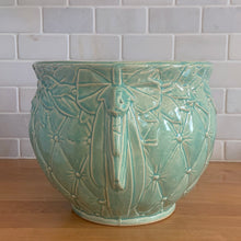 Load image into Gallery viewer, Large vintage Tierra Cushion jardiniere planter pot, aqua gloss glaze, features an overlapping floral leaf pattern around the top rim, a diamond quilted body and ribbon handles. Crafted by McCoy Pottery, USA, 1950s. A must-have for any McCoy collector or gardener!

In excellent condition, free from chips, cracks or repairs, with a manufacturer's glaze pops and like defects, see photo. Maker's mark.

Measures 9 x 7 1/4 inches
