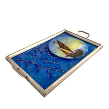 Load image into Gallery viewer, Stunning art deco reverse painted tray with metal frame and handles. Depicts sailboats on the water within a circle on a royal blue background with gold trailing leaves lending itself nicely to a Hollywood Regency or Chinoiserie decor. Germany, 1920s. Perfect as a vanity tray, service barware or even wall art.

The painting is in excellent condition with age-related wear to the frame.

Measures 14 1/8 x 8 3/4 (not incl. handles)
