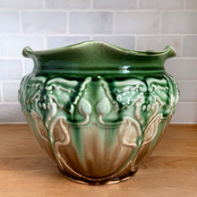Load image into Gallery viewer, Vintage Art Nouveau style green drip glazed majolica ceramic jardiniere planter with floral pattern and scalloped edge. Crafted by WF Needham, England, early 1900s. Fill this beauty with your favourite plants or use as decor!

In as found condition, with chip and L shaped crack. Marked England.

Measures 8 x 6 1/4 inches
