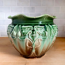 Load image into Gallery viewer, Vintage Art Nouveau style green drip glazed majolica ceramic jardiniere planter with floral pattern and scalloped edge. Crafted by WF Needham, England, early 1900s. Fill this beauty with your favourite plants or use as decor!

In as found condition, with chip and L shaped crack. Marked England.

Measures 8 x 6 1/4 inches
