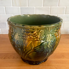 Load image into Gallery viewer, Vintage Art Nouveau drip glazed majolica footed ceramic jardiniere planter features a floral pattern in green, ochre and navy, with scalloped rim. Attributed to WF Needham, England, early 1900s. Fill this beauty with your favourite plants or use as decor!

In excellent condition, no chips/cracks/repairs, normal age-related crazing. Unmarked.

Measures 8 x 6 1/4 inches
