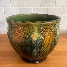 Load image into Gallery viewer, Vintage Art Nouveau drip glazed majolica footed ceramic jardiniere planter features a floral pattern in green, ochre and navy, with scalloped rim. Attributed to WF Needham, England, early 1900s. Fill this beauty with your favourite plants or use as decor!

In excellent condition, no chips/cracks/repairs, normal age-related crazing. Unmarked.

Measures 8 x 6 1/4 inches
