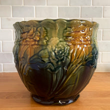 Load image into Gallery viewer, Vintage Art Nouveau drip glazed majolica footed ceramic jardiniere planter features a floral pattern in green, ochre and navy, with scalloped rim. Attributed to WF Needham, England, early 1900s. Fill this beauty with your favourite plants or use as decor!

In excellent condition, no chips/cracks/repairs, normal age-related crazing. Unmarked.

Measures 8 x 6 1/4 inches
