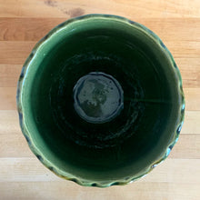 Load image into Gallery viewer, Vintage Art Nouveau drip glazed majolica footed ceramic jardiniere planter features a floral pattern in green, ochre and navy, with scalloped rim. Attributed to WF Needham, England, early 1900s. Fill this beauty with your favourite plants or use as decor!

In excellent condition, no chips/cracks/repairs, normal age-related crazing. Unmarked.

Measures 8 x 6 1/4 inches
