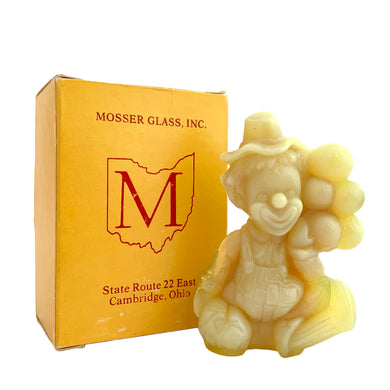 Vintage Arty All the World Loves a Clown vaseline uranium slag glass figurine. Crafted by Mosser Glass, USA, 1981 - 1982. This adorable little clown holding a bunch of balloons glows beautifully under black light. An adorable collectible!

In like new condition, in original box with leaflet.

Measures 2 3/4 x 1 3/8 x 3 1/2 inches